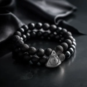 Double-wrap bracelet made of black lava stone beads with a sterling silver charm engraved with the Quantum Pulse logo.